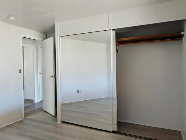 a view of walk in closet with empty racks