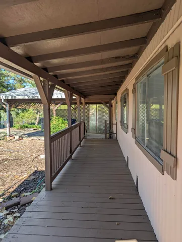 a view of a porch with wooden floor and stairs