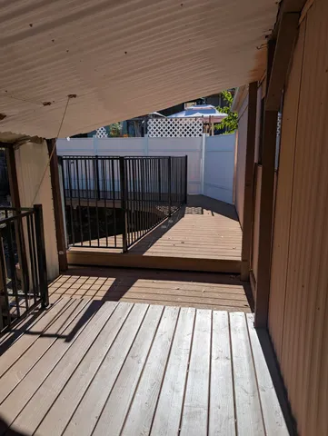 a view of balcony with wooden floor