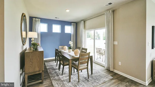 a kitchen with stainless steel appliances kitchen island granite countertop a refrigerator a stove a microwave oven a sink with island and chairs