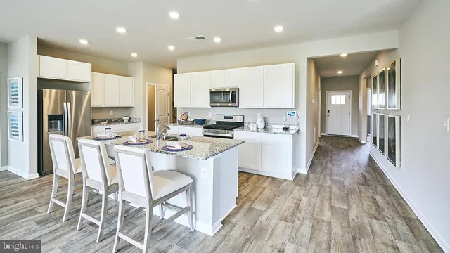 a living room with kitchen island furniture and a wooden floor