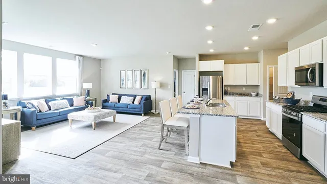 a kitchen with a stove a sink and a refrigerator