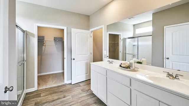a bathroom with a tub shower and sink
