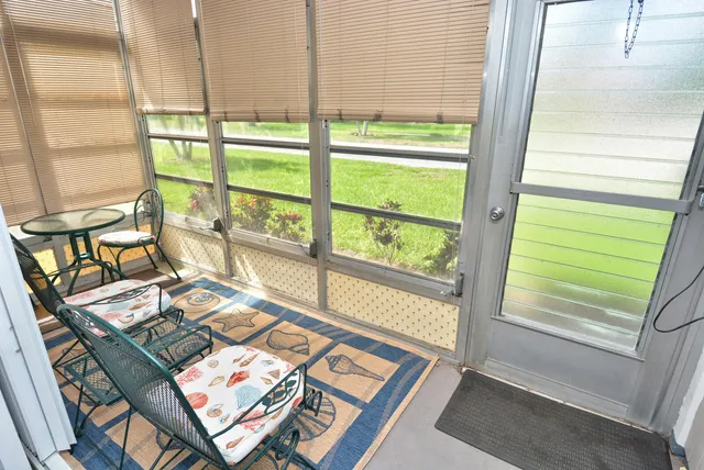 a view of a living room filled with furniture and a window