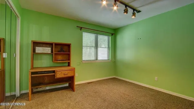 a room with a window and a dresser