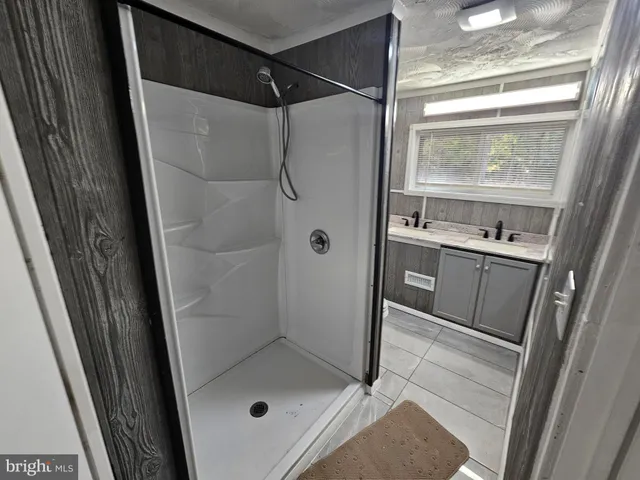 a bathroom with a shower and a sink