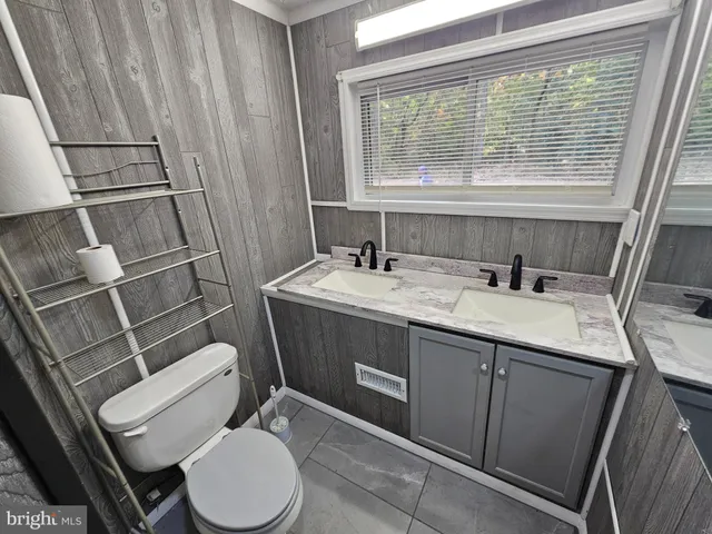 a bathroom with a sink a toilet and tub