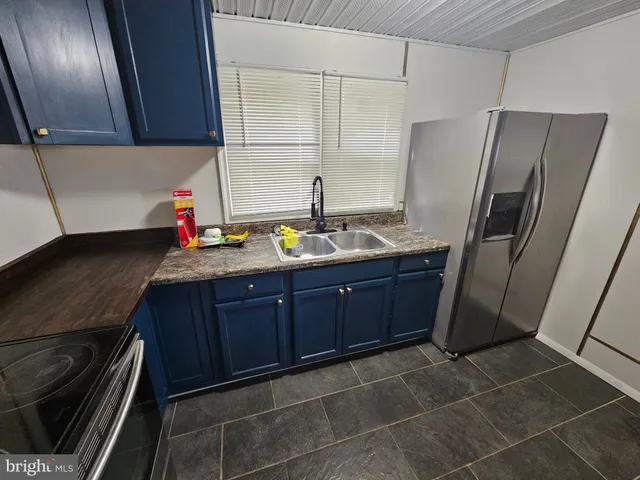 a kitchen with stainless steel appliances a sink stove and refrigerator