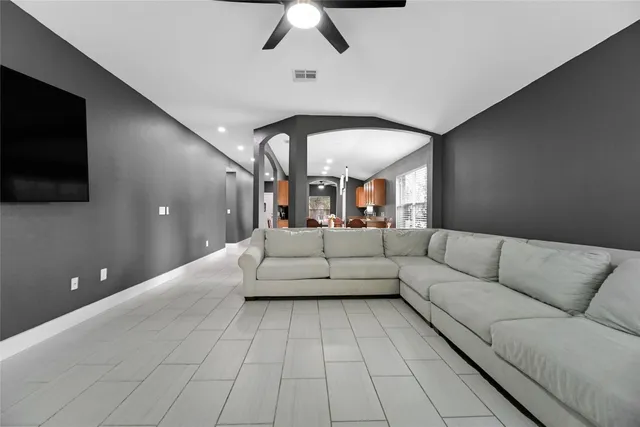 a living room with furniture and a flat screen tv