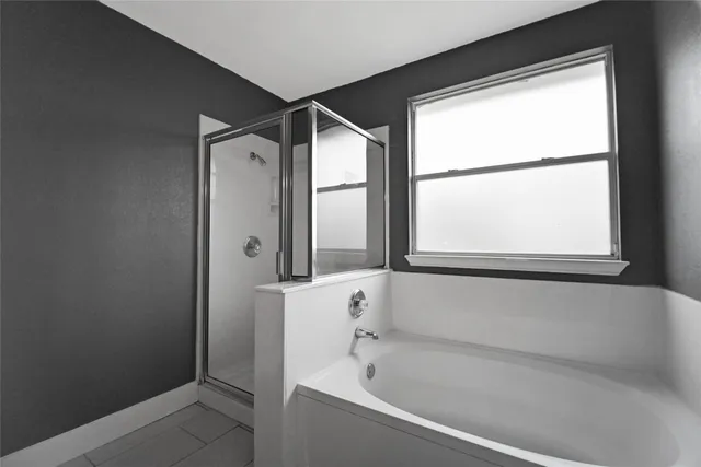 a bathroom with a bathtub and a shower