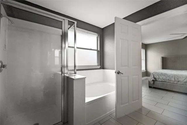 a bathroom with a tub and shower