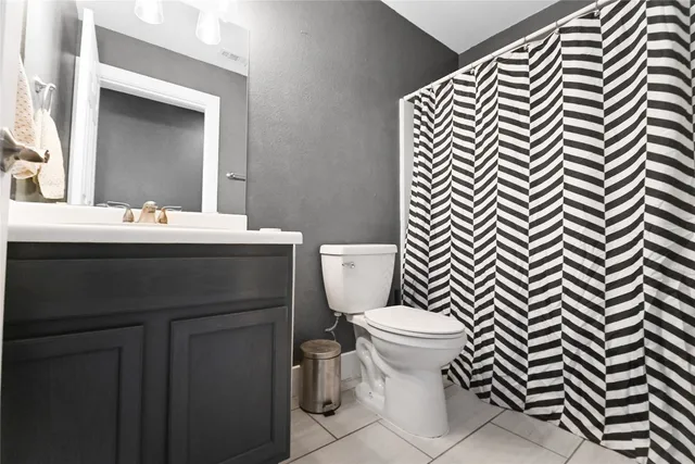 a bathroom with a sink and mirror with toilet