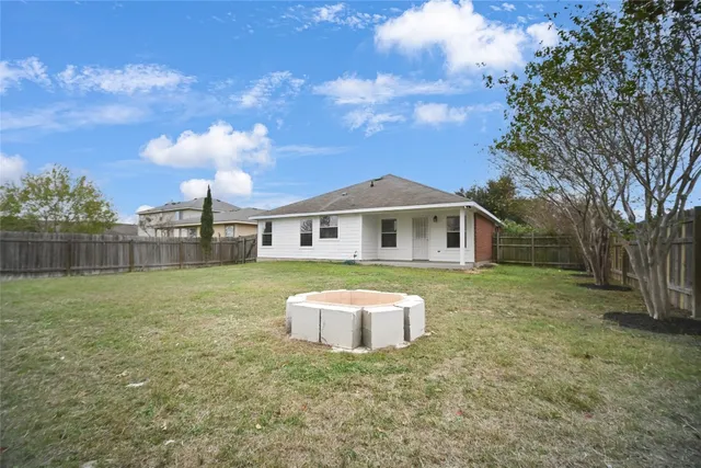 a front view of house with yard and trees