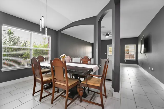 a dining room with furniture and window