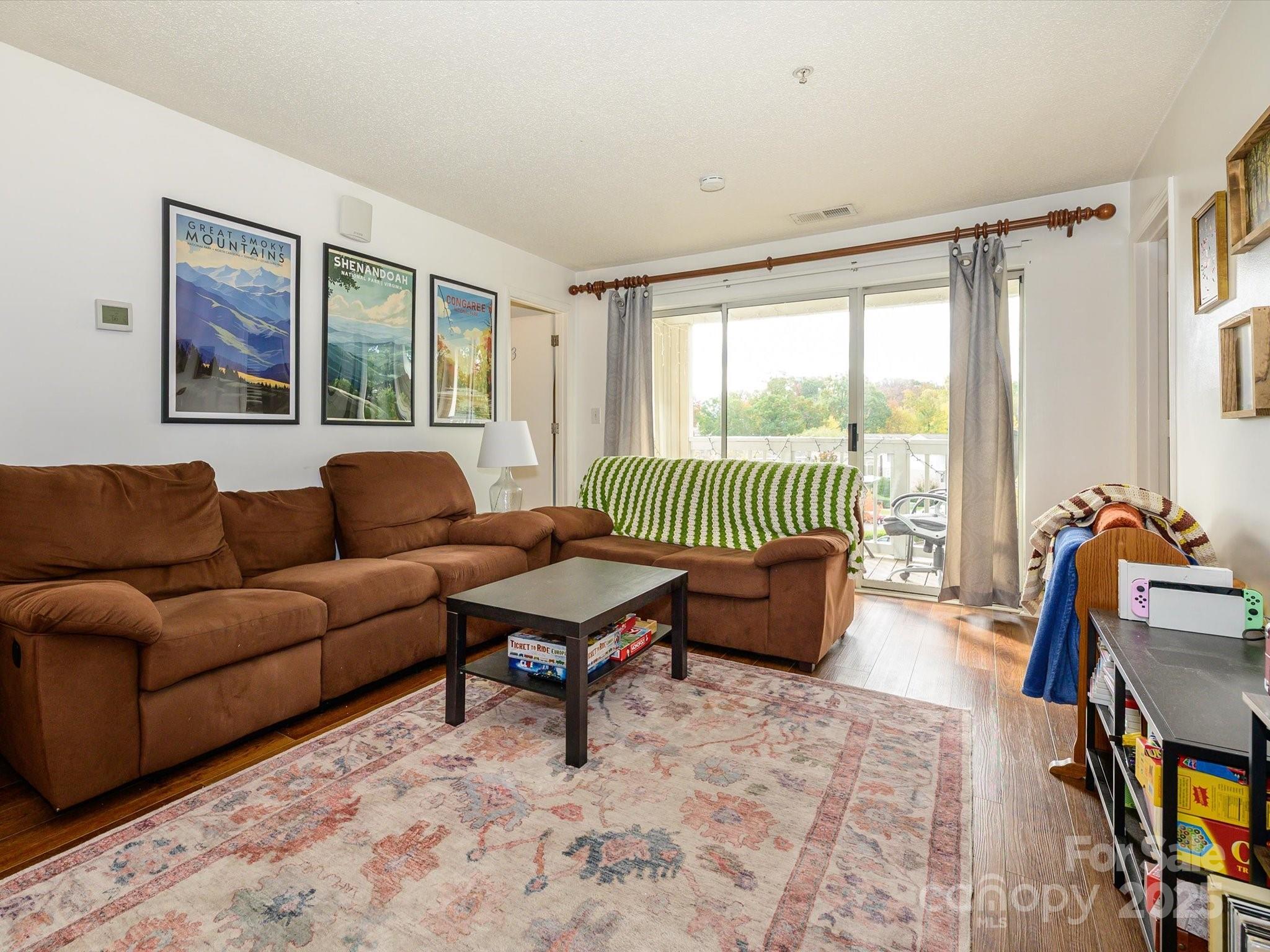 10005 Graduate Lane, Unit K Charlotte, NC 28262 - Photo 11 of 25 a living room with furniture and a window