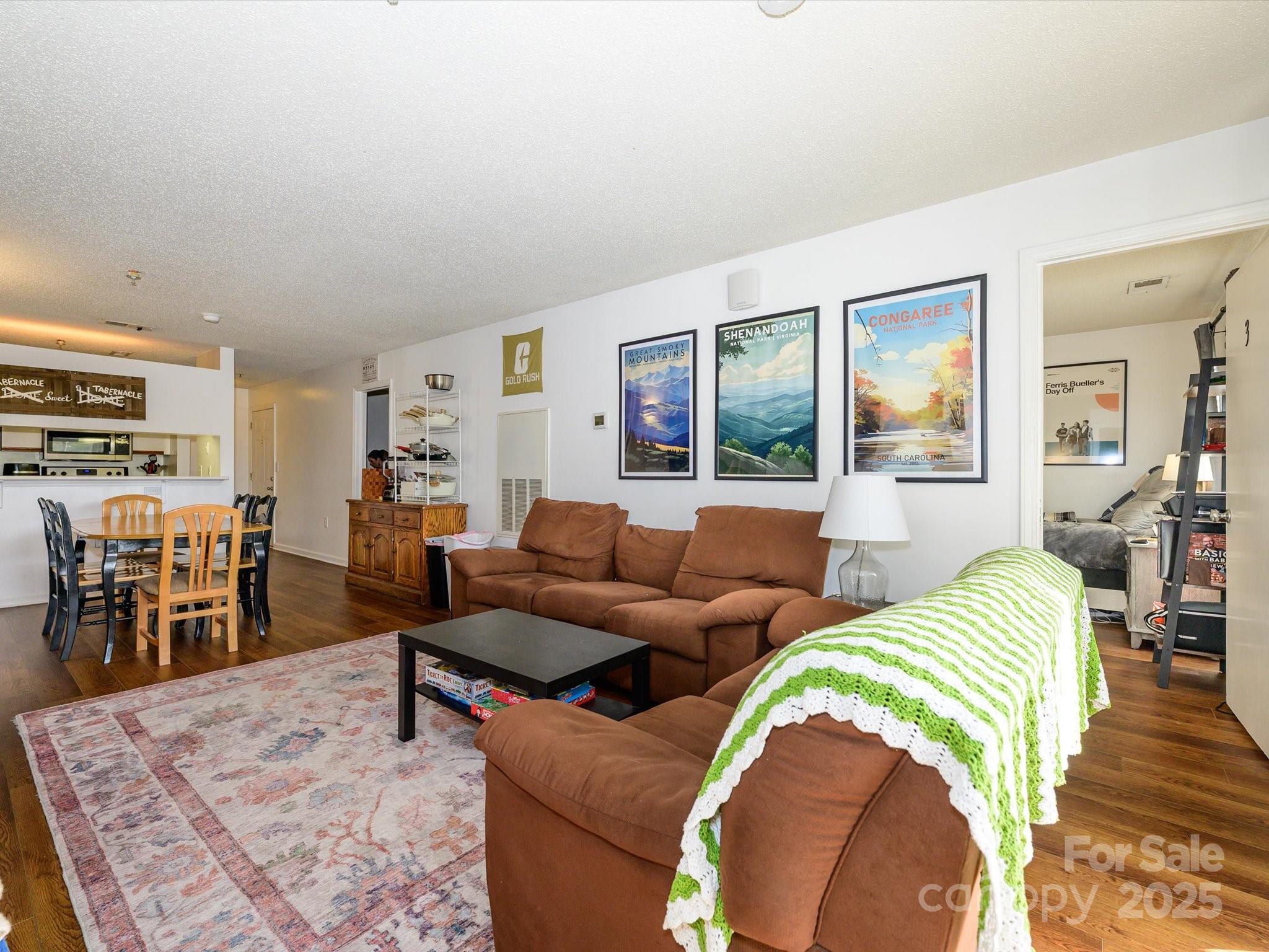 10005 Graduate Lane, Unit K Charlotte, NC 28262 - Photo 12 of 25 a living room with furniture and a wooden floor