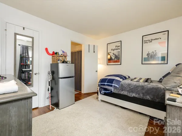 a living room with furniture and a refrigerator
