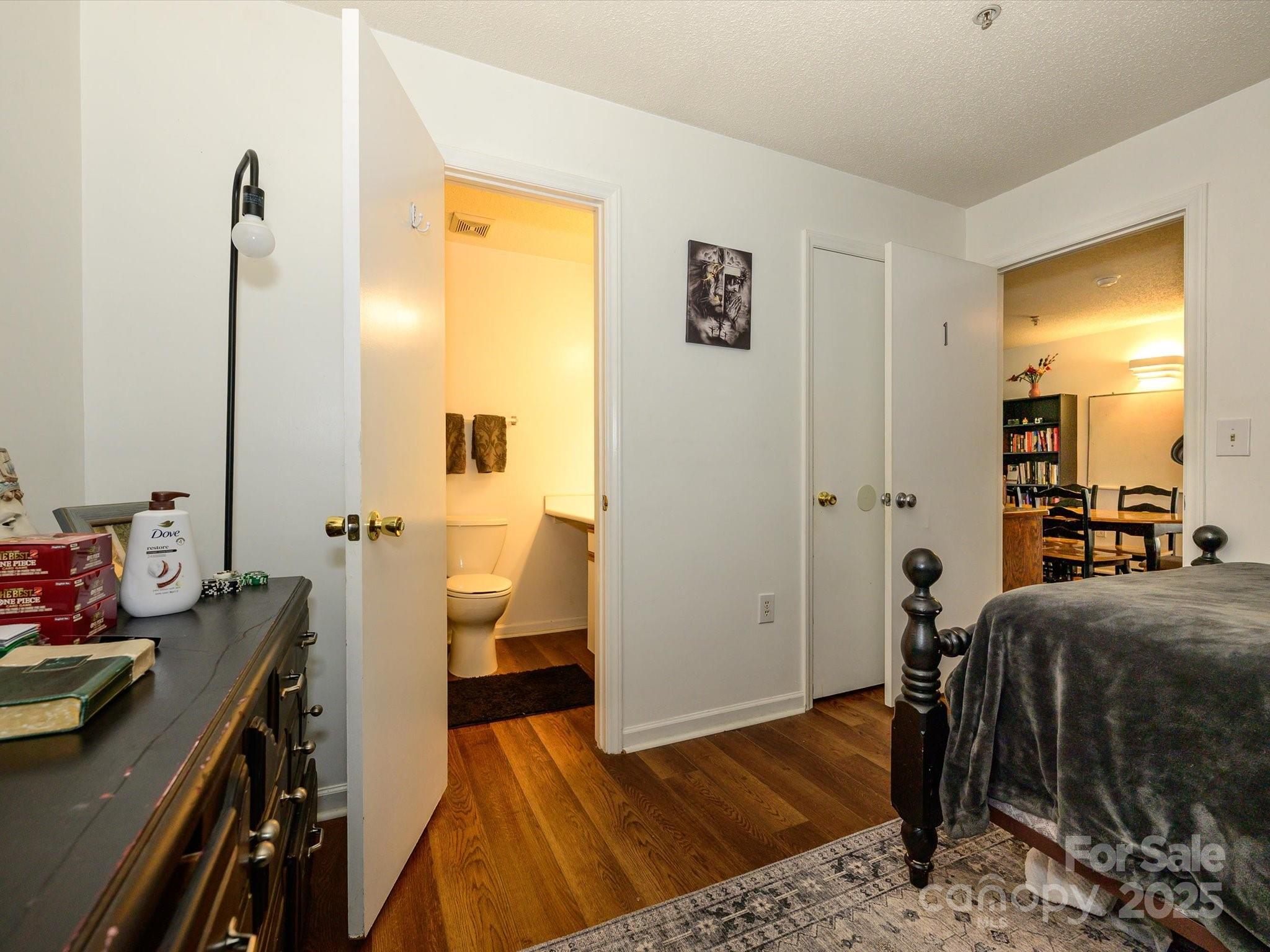 10005 Graduate Lane, Unit K Charlotte, NC 28262 - Photo 17 of 25 a bedroom with a bed and wooden floor