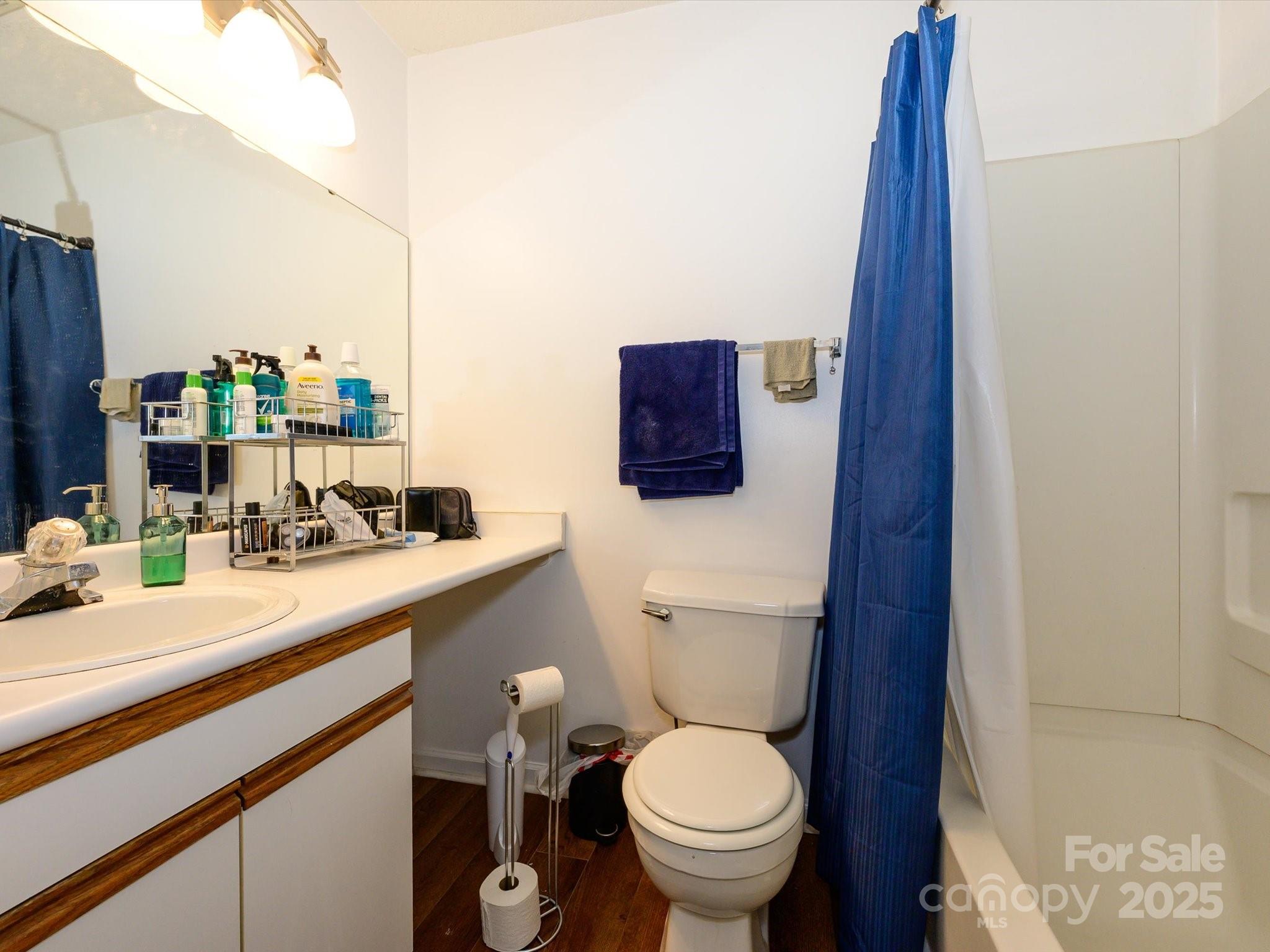 10005 Graduate Lane, Unit K Charlotte, NC 28262 - Photo 21 of 25 a bathroom with a sink a toilet and mirror