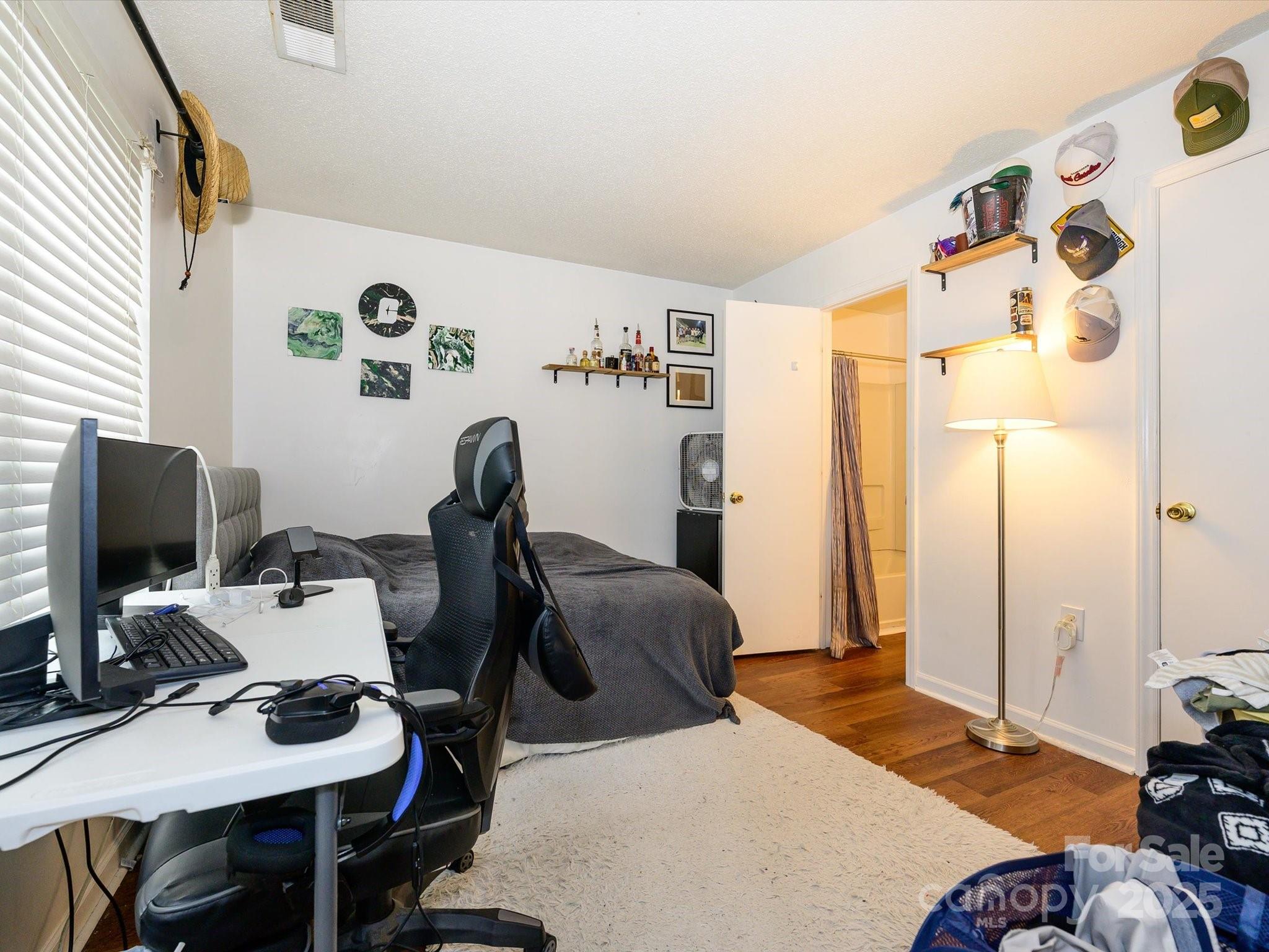 10005 Graduate Lane, Unit K Charlotte, NC 28262 - Photo 22 of 25 a bedroom with furniture and a window