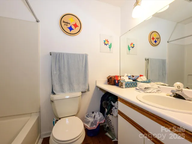 a bathroom with a sink a toilet and a shower curtain