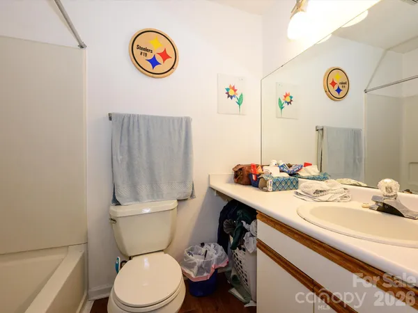 a bathroom with a sink a toilet and a shower curtain