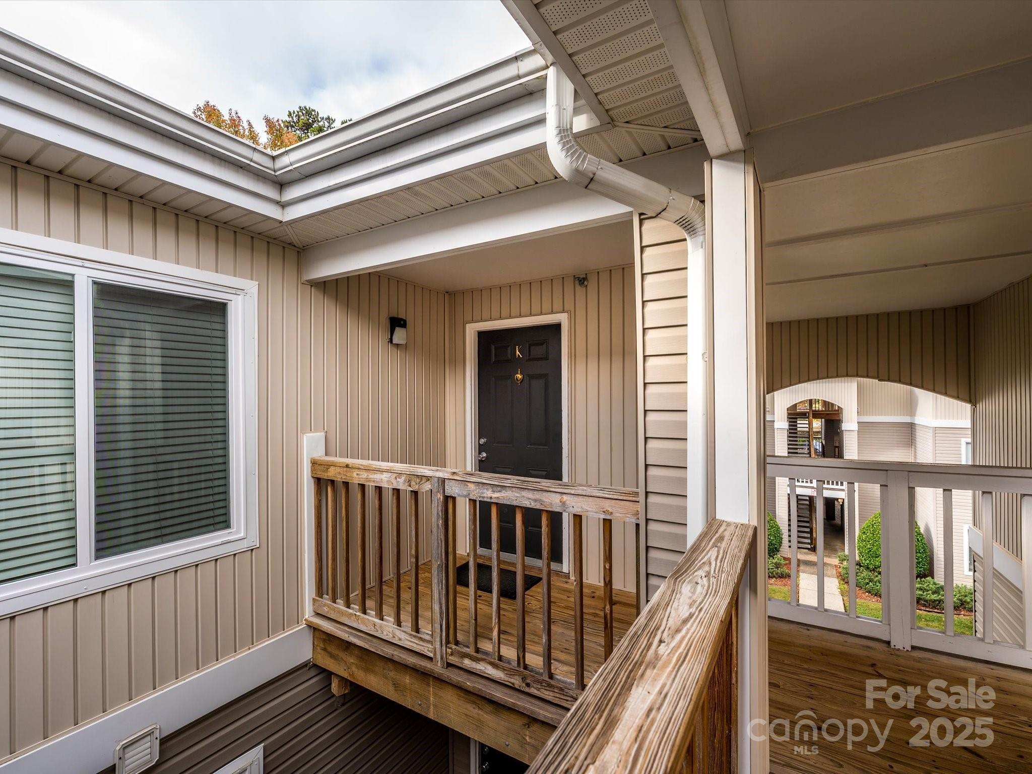10005 Graduate Lane, Unit K Charlotte, NC 28262 - Photo 3 of 25 a view of balcony with a deck