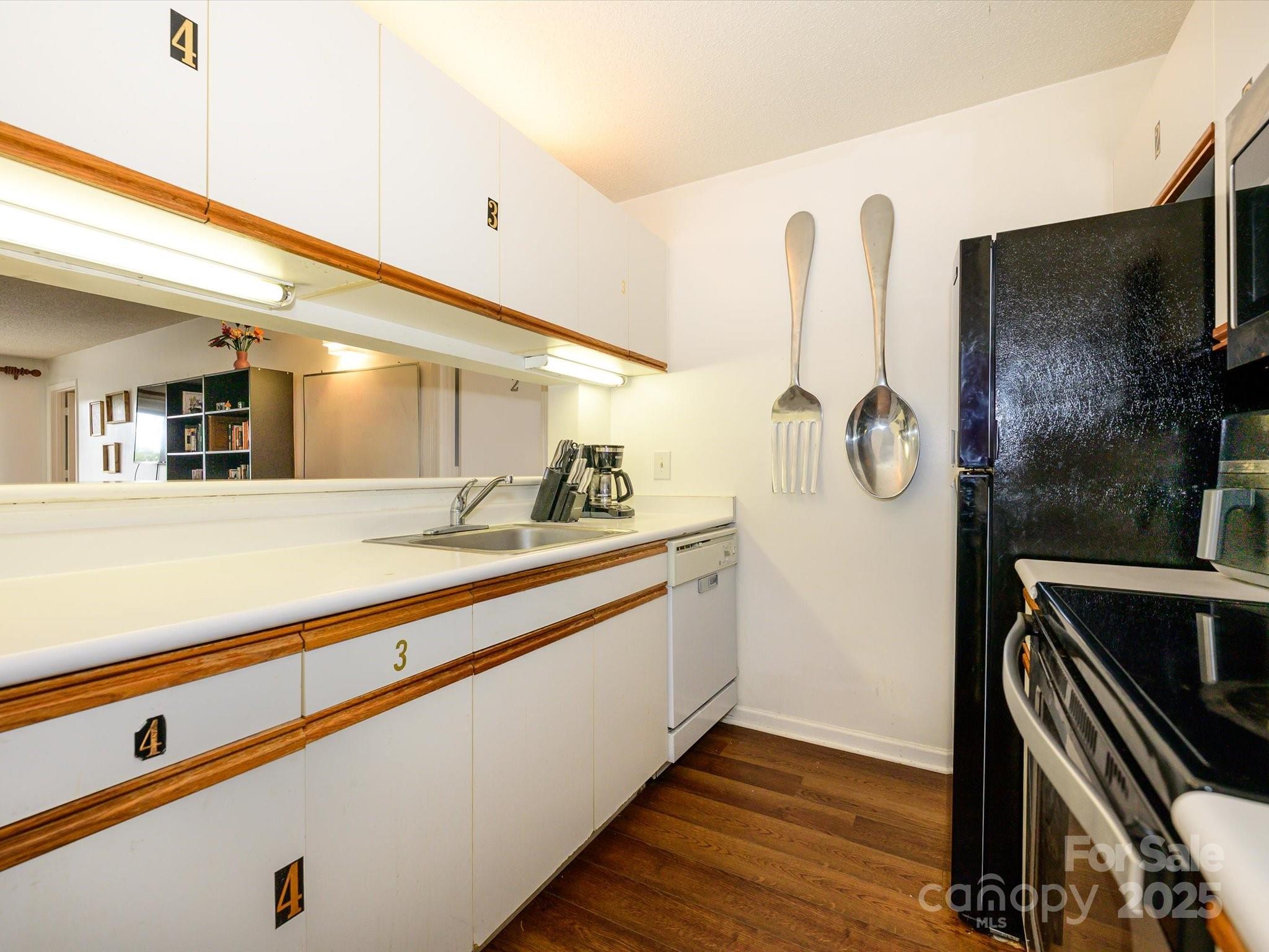 10005 Graduate Lane, Unit K Charlotte, NC 28262 - Photo 5 of 25 a kitchen with stainless steel appliances granite countertop a sink and a refrigerator