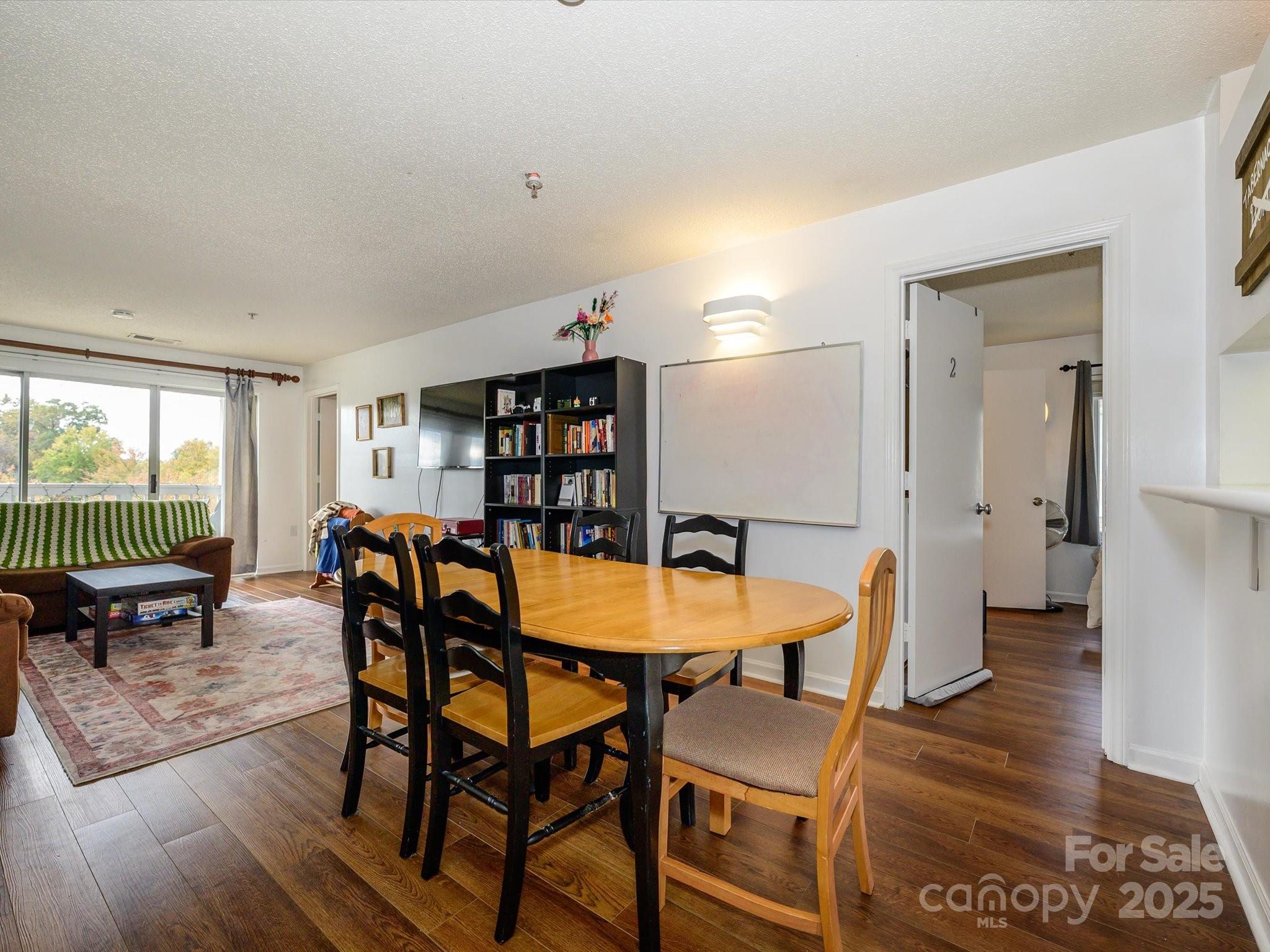 10005 Graduate Lane, Unit K Charlotte, NC 28262 - Photo 8 of 25 a dining room with furniture and wooden floor