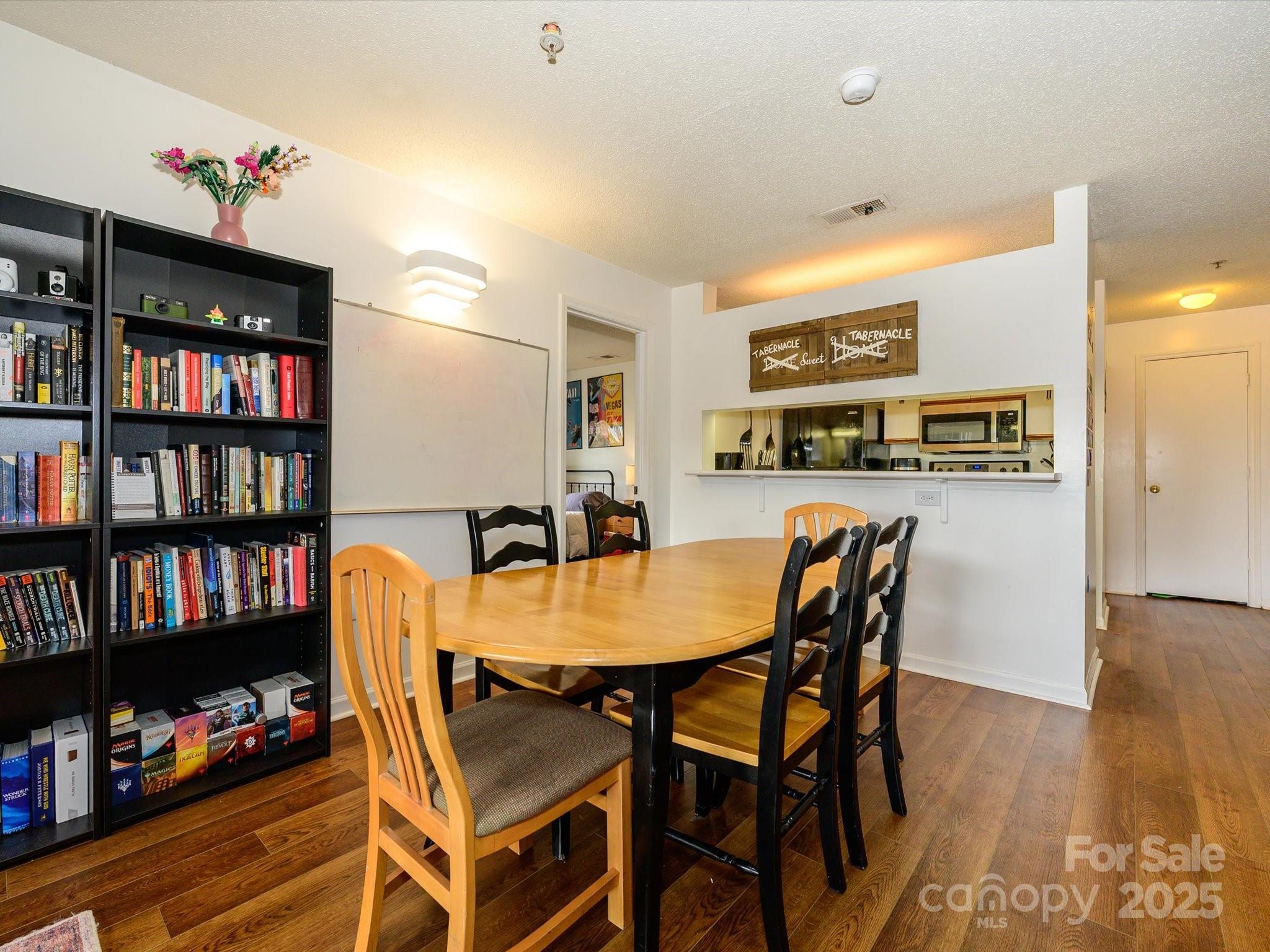 10005 Graduate Lane, Unit K Charlotte, NC 28262 - Photo 9 of 25 a dining room with furniture and wooden floor