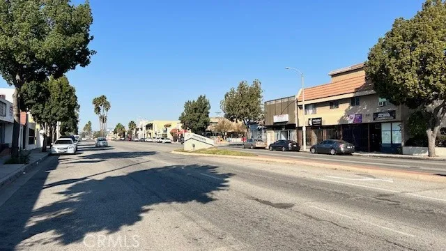a city street lined with buildings and trees