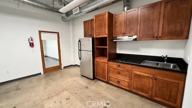 a kitchen with stainless steel appliances a refrigerator and cabinets