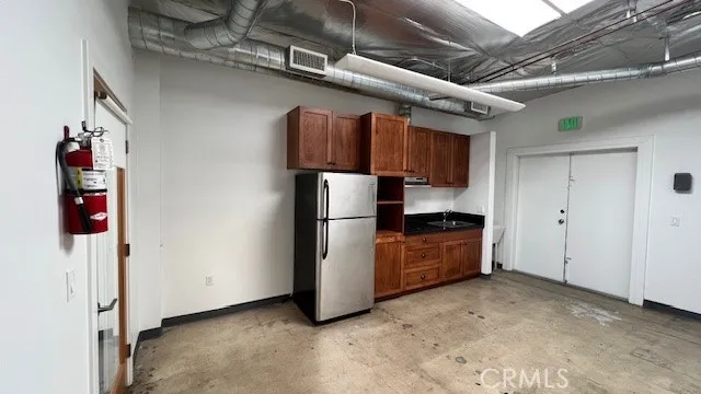 a kitchen with stainless steel appliances granite countertop a refrigerator and a stove