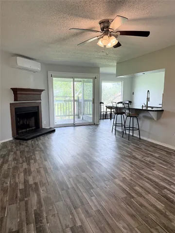 a view of a livingroom with furniture chandelier fan and wooden floor