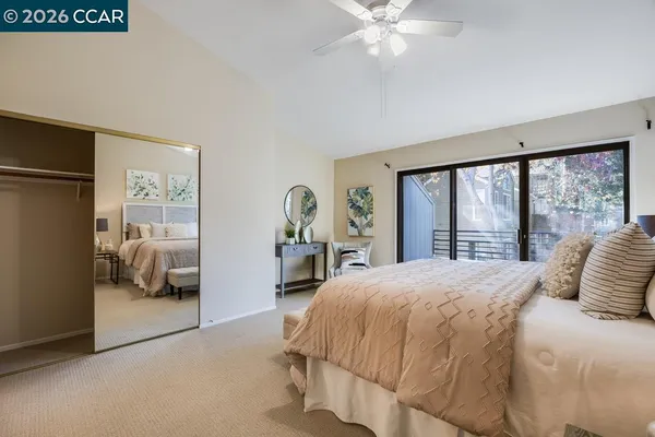 a bedroom with a large bed and a large window