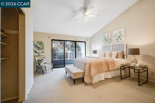 a bedroom with a large bed and a chandelier