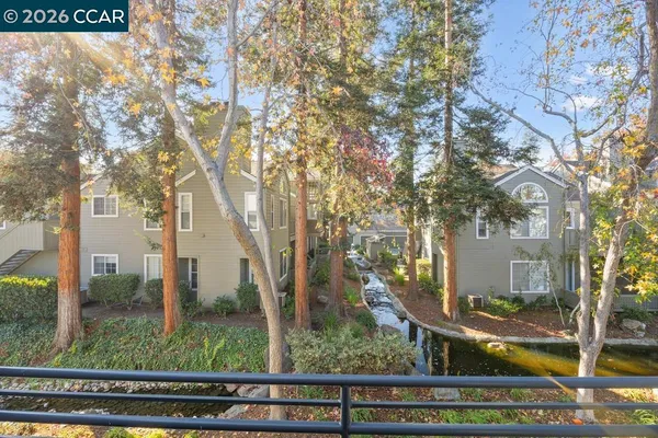 a view of a house with a tree in the background