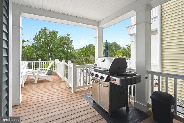 a view of a balcony with chair and wooden floor
