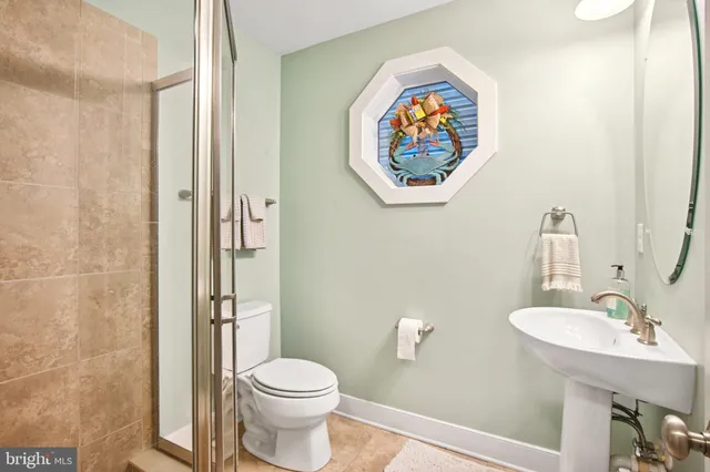 a bathroom with a toilet a sink and mirror