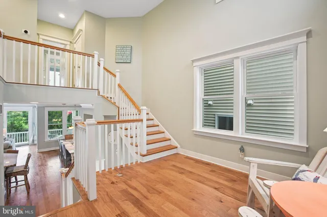 a bed sitting in a spacious bedroom next to a window