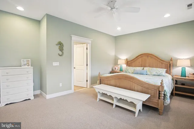 a bedroom with a bed and ceiling fan