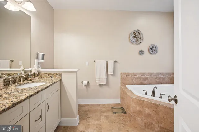 a bathroom with a tub shower and window