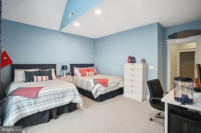 a bedroom with two beds and a window