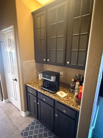 a spacious bedroom with a bed and a chandelier