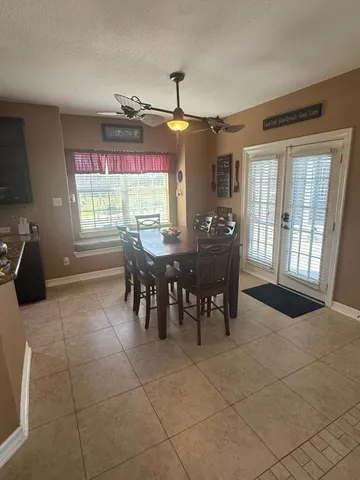 a view of a room with furniture and chandelier