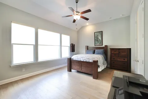 a bedroom with a large bed and a window