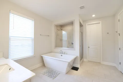 a bathroom with a bathtub and window
