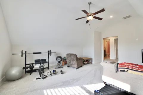 a work room with furniture and ceiling fan