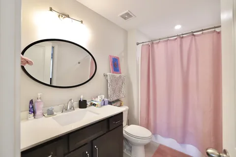 a bathroom with a sink a mirror a toilet and a mirror