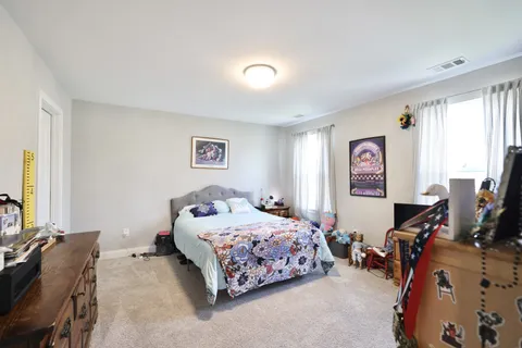 a bedroom with a bed and a dresser